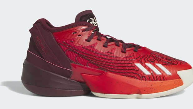 Side view of Donovan Mitchell's red and black adidas shoe.